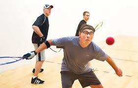 In racquetball, players play with bigger stringed racquet heads, and a bouncier but larger than a squash ball, on a longer but narrower court. Middle Age Players Often Reign In Racquetball Chesterfield Observer