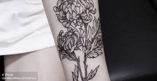 forearm tattoo of a chrysanthemum flower