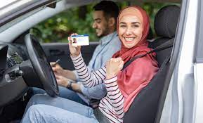 glad muslim woman in hijab show driving