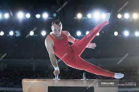male gymnast performing on pommel horse
