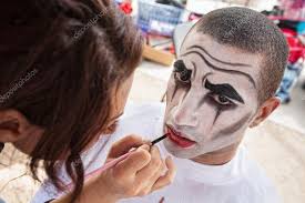 makeup artist lining lips of circus
