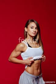 Sexy Fit Woman In A Cap Posing On Red Background Image Of Fitness
