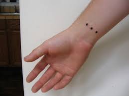 three dot tattoos in triangular pattern