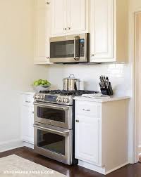 How to hang microwave ovens. White Kitchen With Over The Stove Microwave Transitional Kitchen