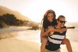 Happy man carrying a woman on his back walking on beach - Free Photo  (5Xw6k0) - Noun Project