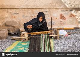 omani woman weaving carpet