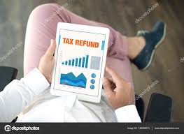 Business Charts And Graphs On Screen With Tax Refund Title