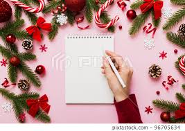 woman writing christmas to do list on