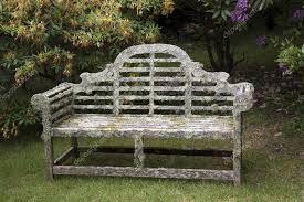 an old wooden garden seat covered in