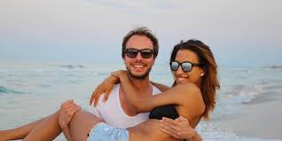 Image result for A picture of a man and woman on a deserted island taking a picture by fried fish and fruits.