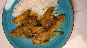trini curry fish on a fireside