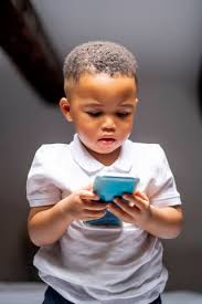 cute boy using smart phone at home
