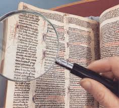 Image of a magnifying glass over an old book Link to help searching for information