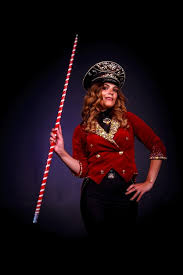 female magician with red and white cane
