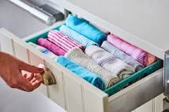How do you organize kitchen towels in a drawer?