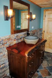 Aside from serving as a mount for your sink and offering storage and counter space, a beautiful vanity can add major impact to your bathroom. Rustic Blue Bathroom With Live Edge Countertop Hgtv