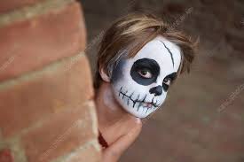 boy with face painting of skull stock