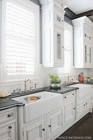 In this example, a cabinetry valance was installed to bridge the two wall cabinets flanking a large center window. Large Kitchen Window Design Ideas Heather Hungeling Design