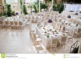 Awesome Wedding Hall With White Chairs And Purple Flowers On