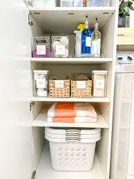 organizing a deep laundry cabinet