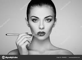 woman painting lipstick stock photo