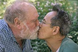 Senior Gay Couple Kissing In A Park by Stocksy Contributor Joselito  Briones - Stocksy