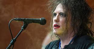 why does robert smith still wear makeup