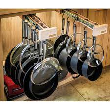 Why should heavy pots and pans be stored where they should be?