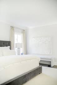 dark gray velvet bed with cream rug