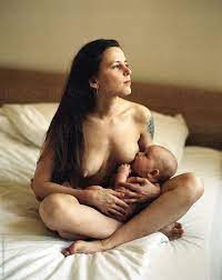 Naked Mother Breastfeeding Her Child