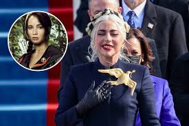 Gaga's outfit also featured matching gloves and her jewelry included a large golden dove brooch to symbolize peace and unity. Lady Gaga S Inauguration Brooch Reminds People Of Hunger Games