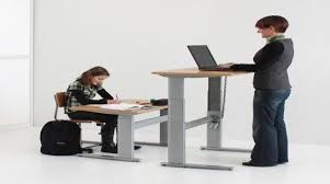 Sit or stand as you work with height adjustable desks from costco.com. Student At Sitting Desk With Teacher At Standing Desk Download Scientific Diagram