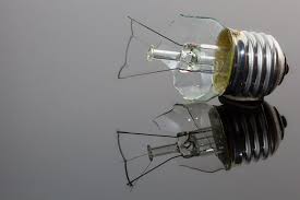 removing a broken lightbulb from its socket