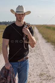 rugged cowboy on a dirt road with reins