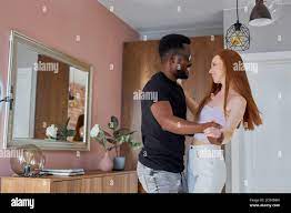 lovely young multiethnic couple dance in living room at home, happy to move  in new apartment, black man and redhead lady are in love Stock Photo - Alamy