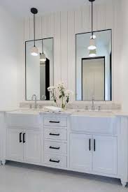 Unusual brass sconces supplement the natural light coming into the room from a large window over the tub. Top 50 Best Bathroom Mirror Ideas Reflective Interior Designs