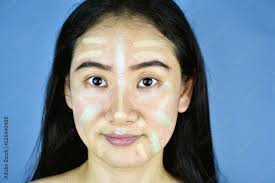 asian woman applying cosmetics makeup