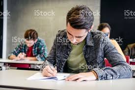 Choose from a curated selection of images licensed under the unsplash license as royalty free photos. Young Man Writing On Paper In Classroom Sitting At Desk Exam Photos Student College Students