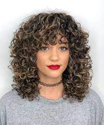Medium length hairstyles for curly hair range from a thick bouncy fringe to loose grown out curls. 21 Best Ways To Have Curly Hair With Bangs In 2021