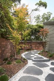 Adding the border of white rocks along with the pink pavers creates a remarkable image. 10 Creative Ways To Use Pebbles For Landscaping