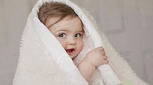 cute infant baby is covering with white