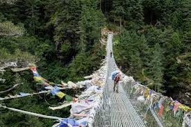 One of the many suspension bridges - that's Madan the other group's porter.  - Picture of Nepal Trek Adventure and Expedition, Kathmandu - Tripadvisor