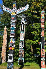 An object (such as an animal or plant) serving as the emblem of a family or clan and often as a. Totem Poles In Stanley Park In Vancouver Canada Encircle Photos