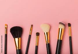 cosmetic makeup brush on a pink