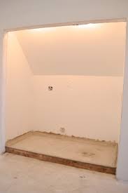 a concrete floor in the laundry closet