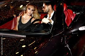 red carpet couple in luxury car