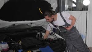 Repair Young Nice Master In Car Workshop Near Open Hood