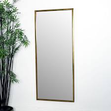 Inspired by the architecture and design popular in the 1920 and 1930s, this beautiful gold wall mirror is sure to make a statement. Large Gold Rectangle Mirror