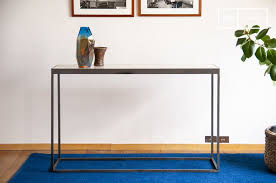 A Marble And Metal Console With A
