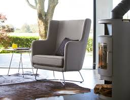 Unique curved high back wing chair design with rich rolled wooden arms offering great scale and grandeur. Rockwell Unscripted High Back Lounge Chair Knoll